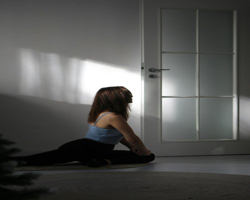 woman doing light stretching at home